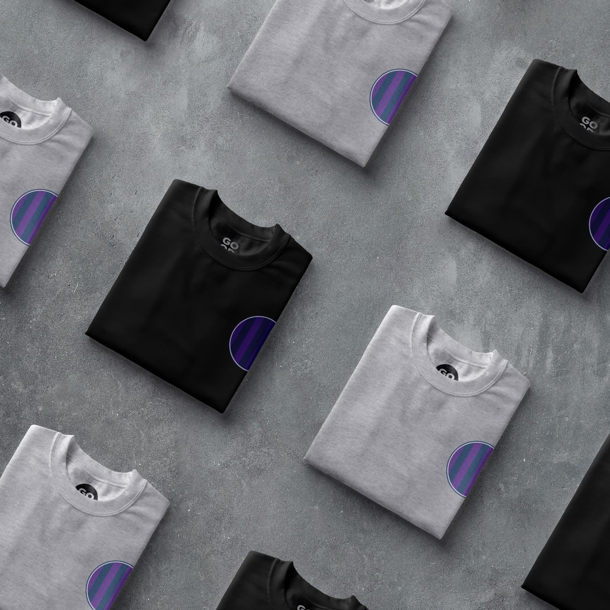 a group of t - shirts sitting on top of a cement floor