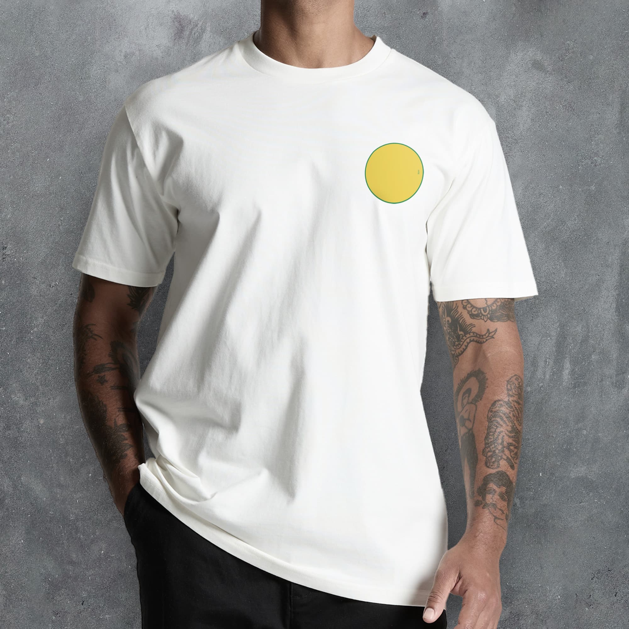 a man wearing a white t - shirt with a yellow circle on it