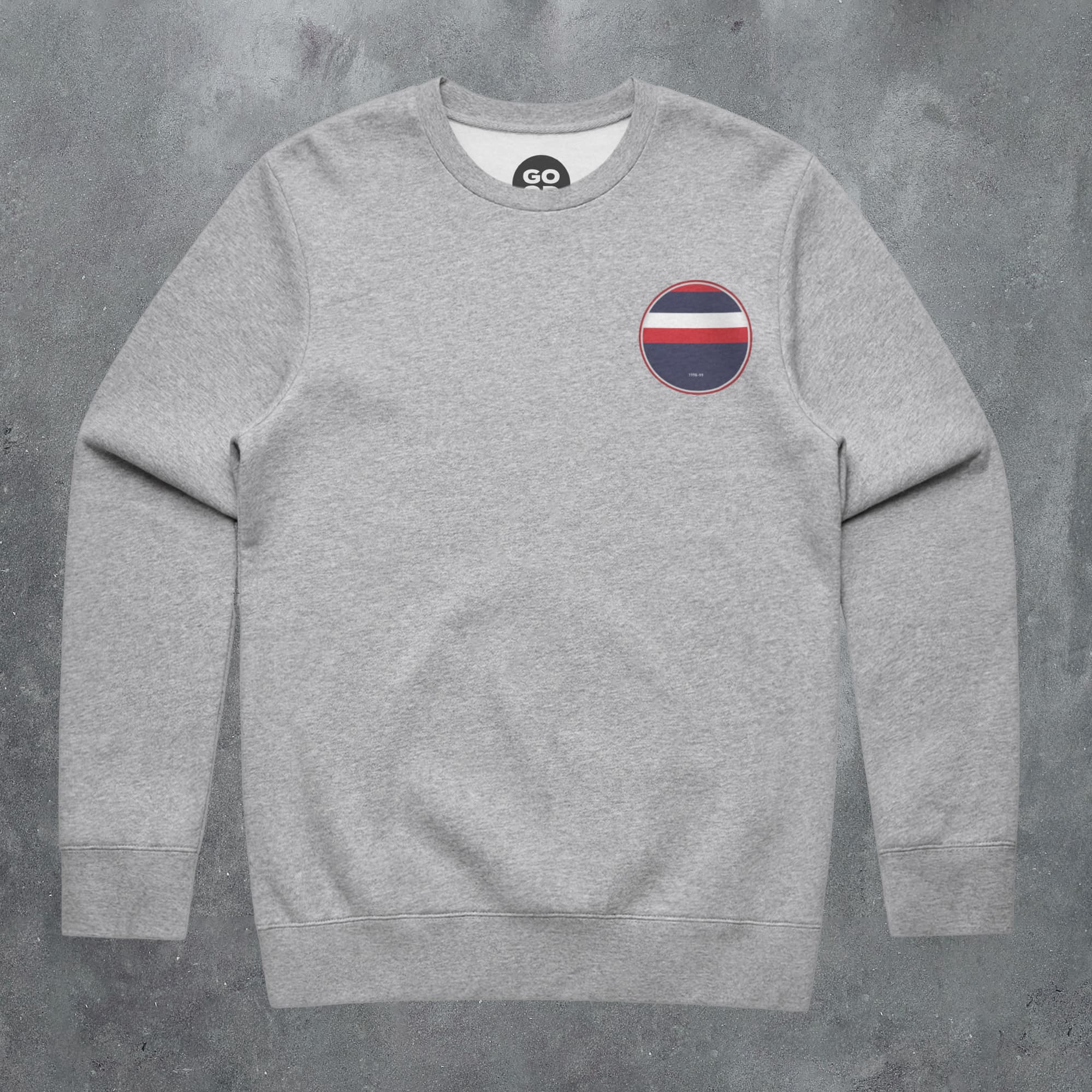 a grey sweatshirt with a red, white and blue circle on the chest
