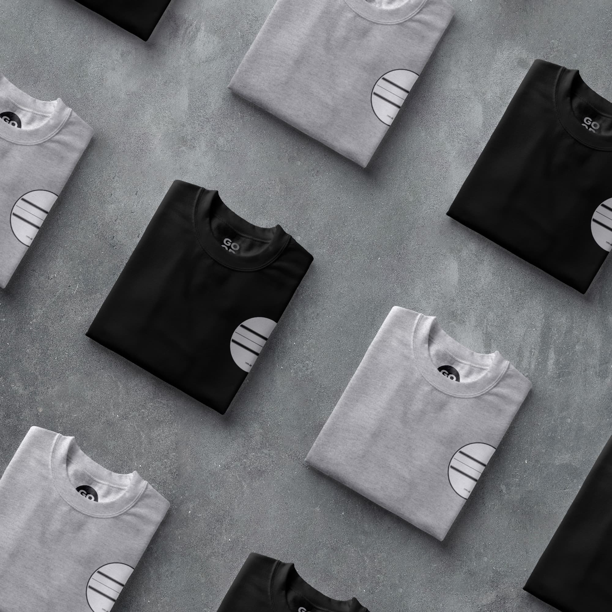 a group of black and white t - shirts sitting on top of a table