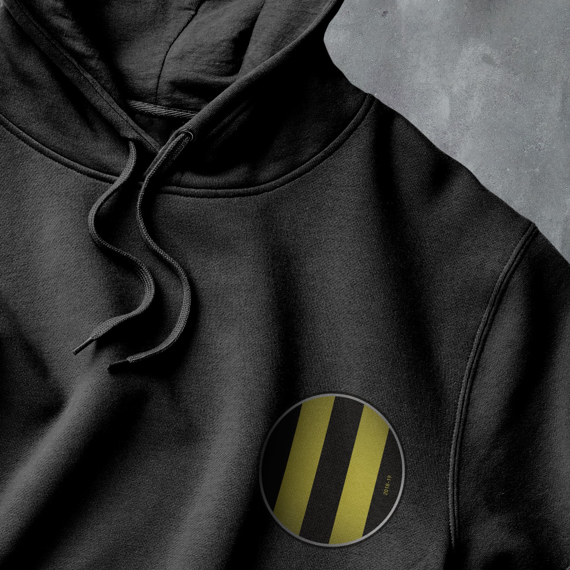 a black hoodie with a yellow stripe on it