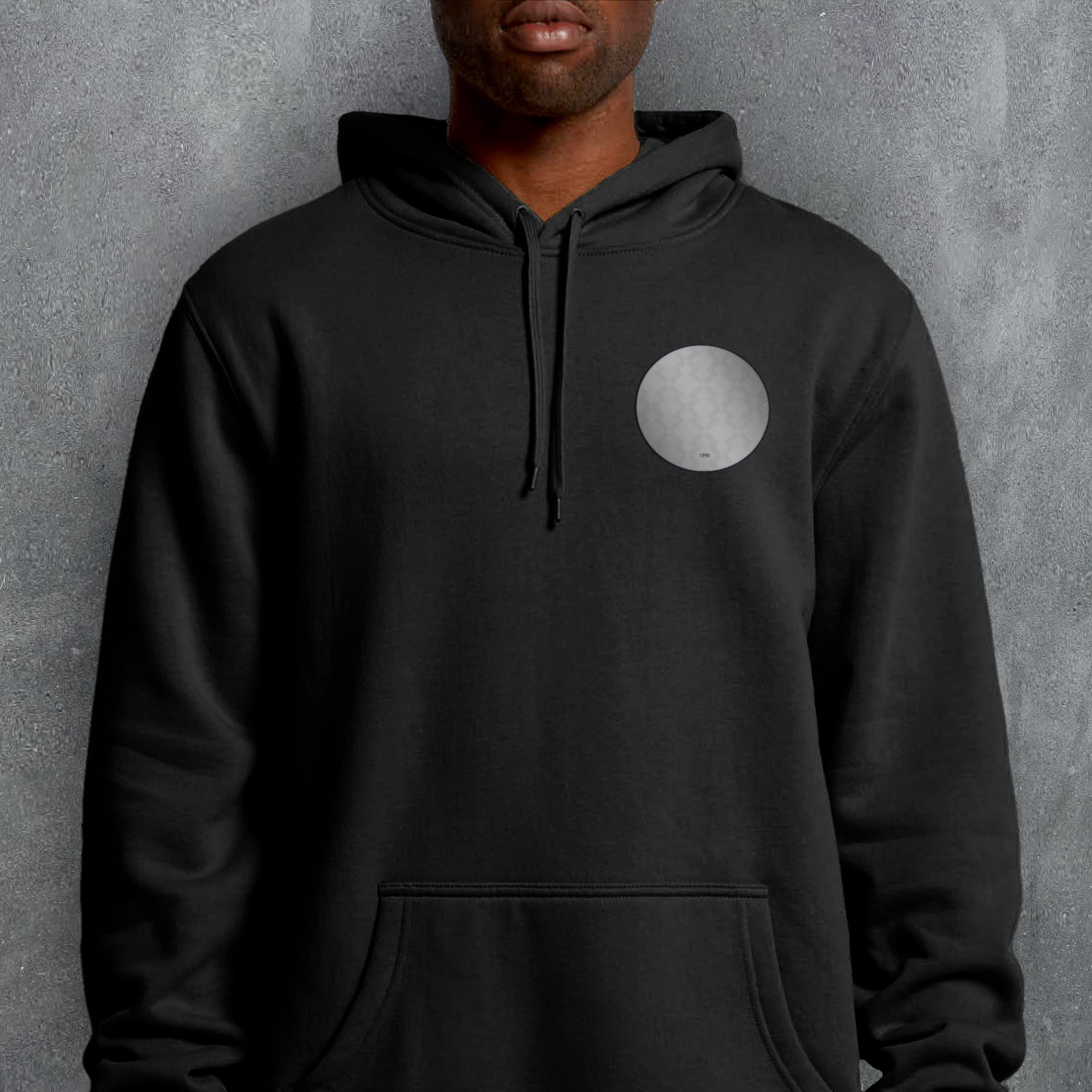 a man wearing a black hoodie with a white circle on it