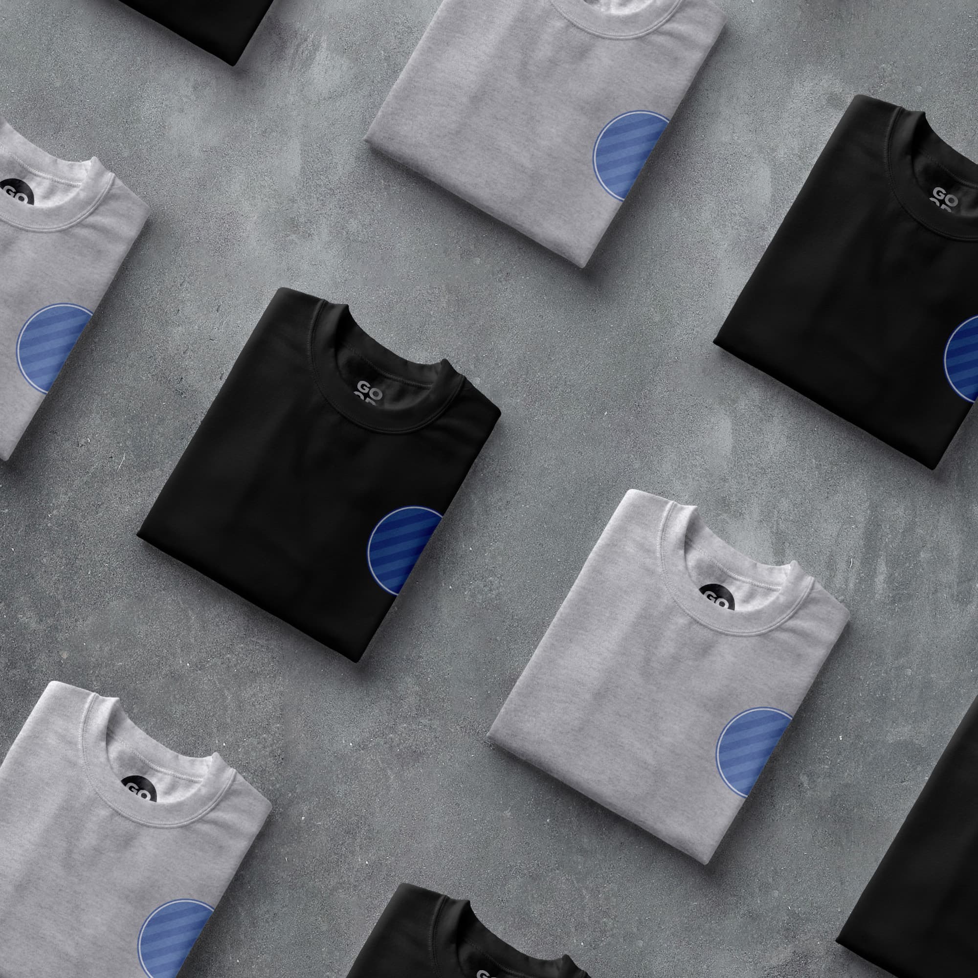 a group of t - shirts sitting on top of a cement floor