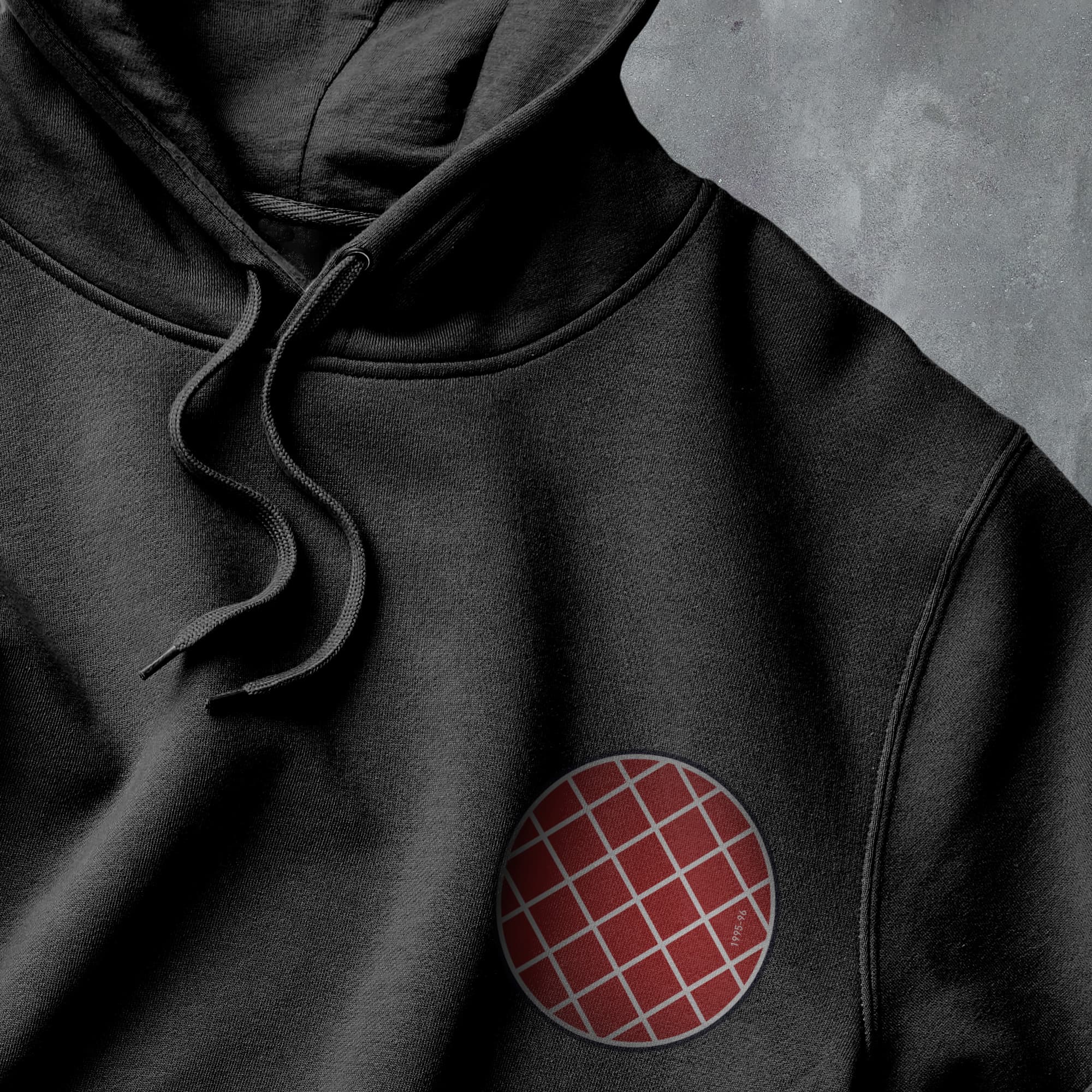 a black hoodie with a red and white circle on it
