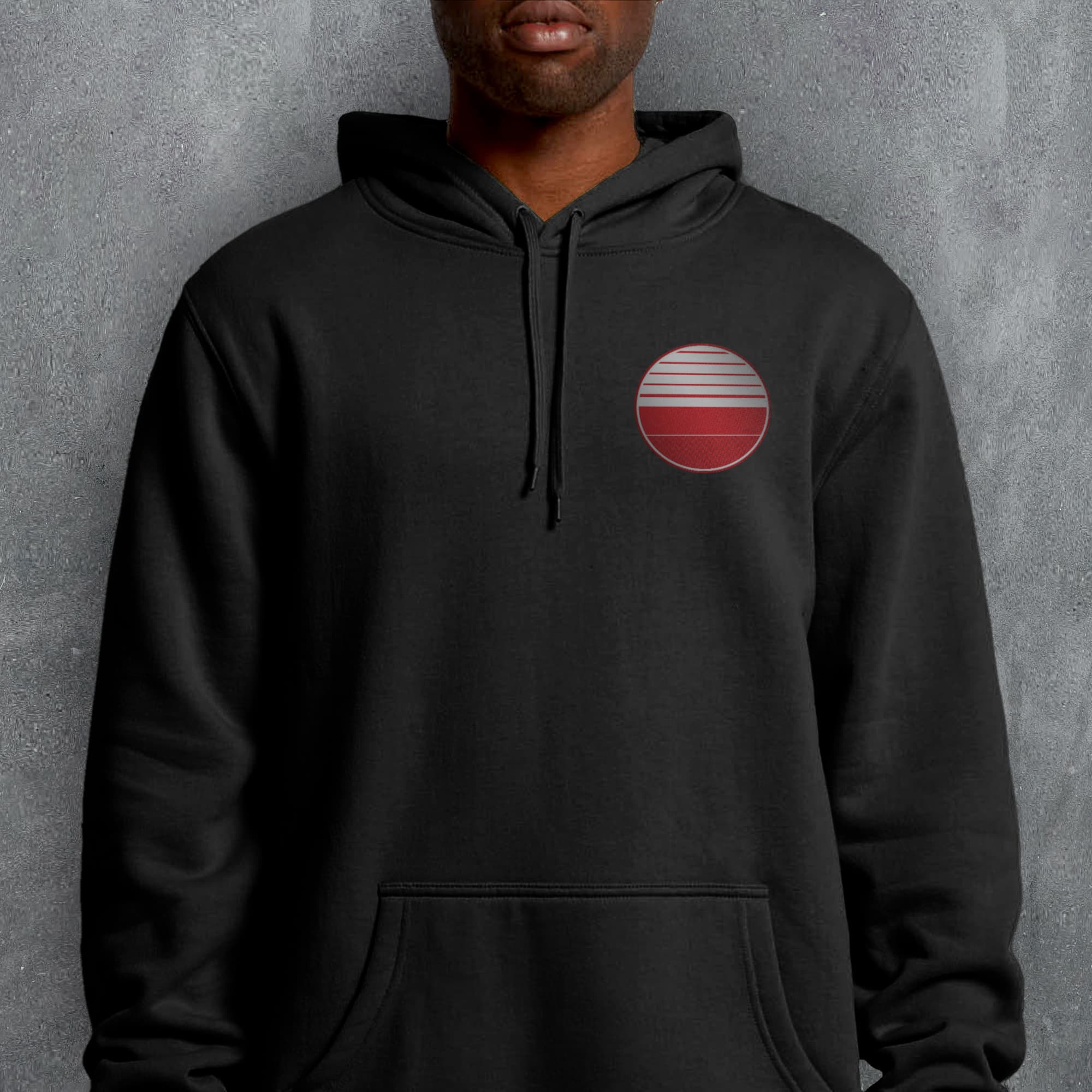a man wearing a black hoodie with a red circle on it
