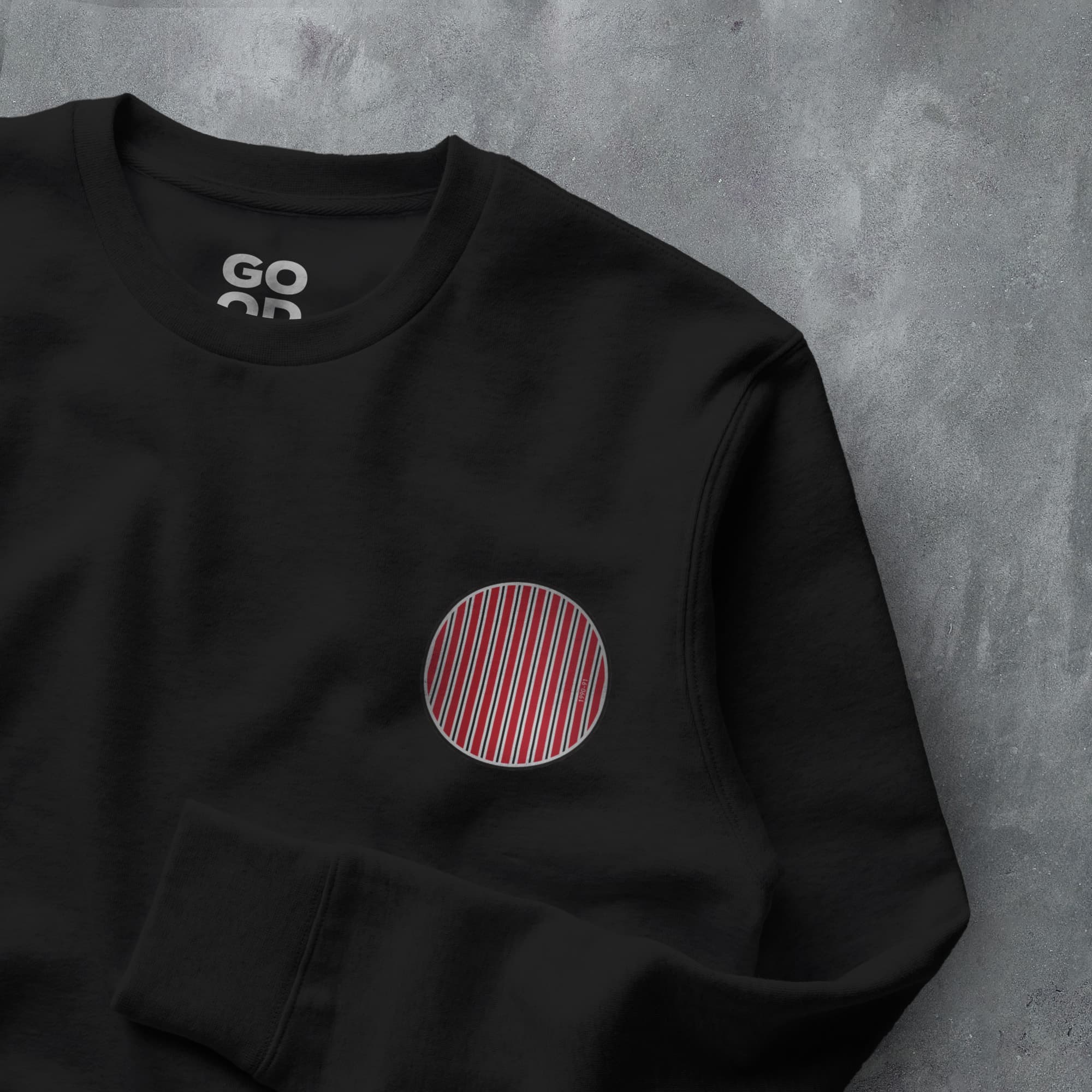 a black sweatshirt with a red and white circle on it