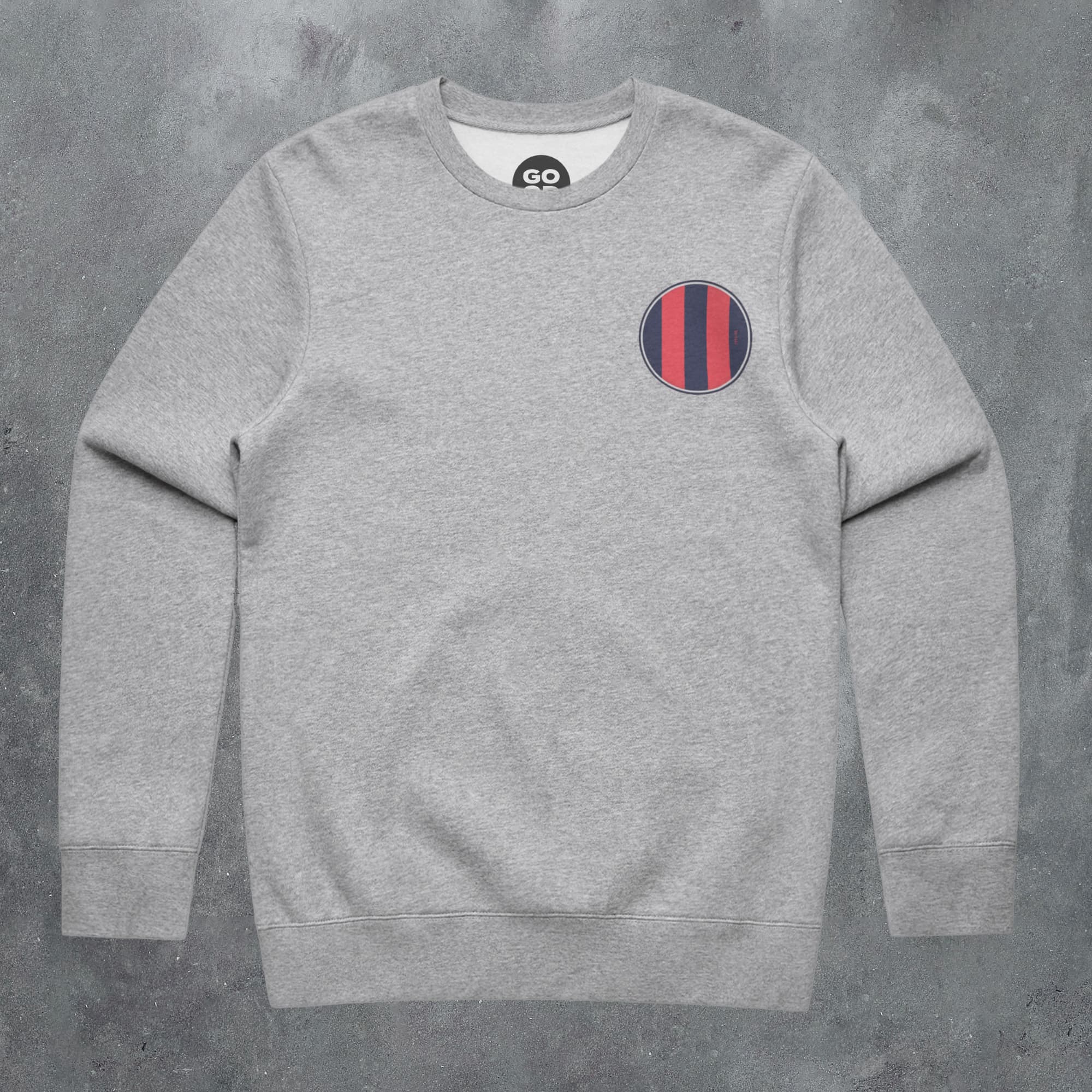 a grey sweatshirt with a red and blue stripe on the chest